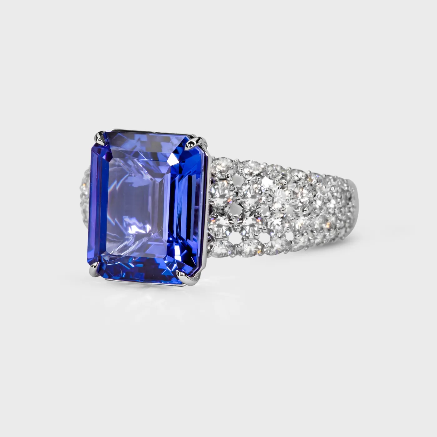 Sorteny Tanzanite white gold ring by ValeOro with an emerald-cut tanzanite on a diamond-paved band, side view