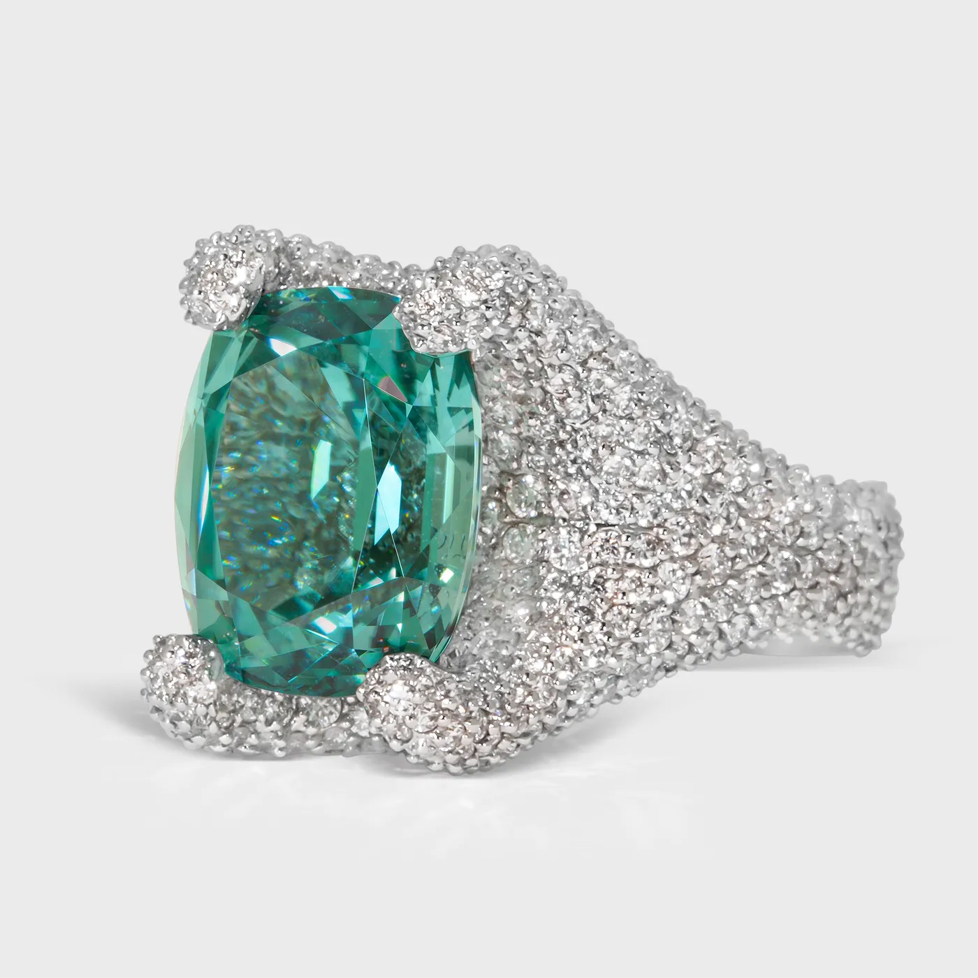 Granada Lagoon white gold ring by ValeOro with a blue-green tourmaline held by diamond-covered prongs, three-quarter view