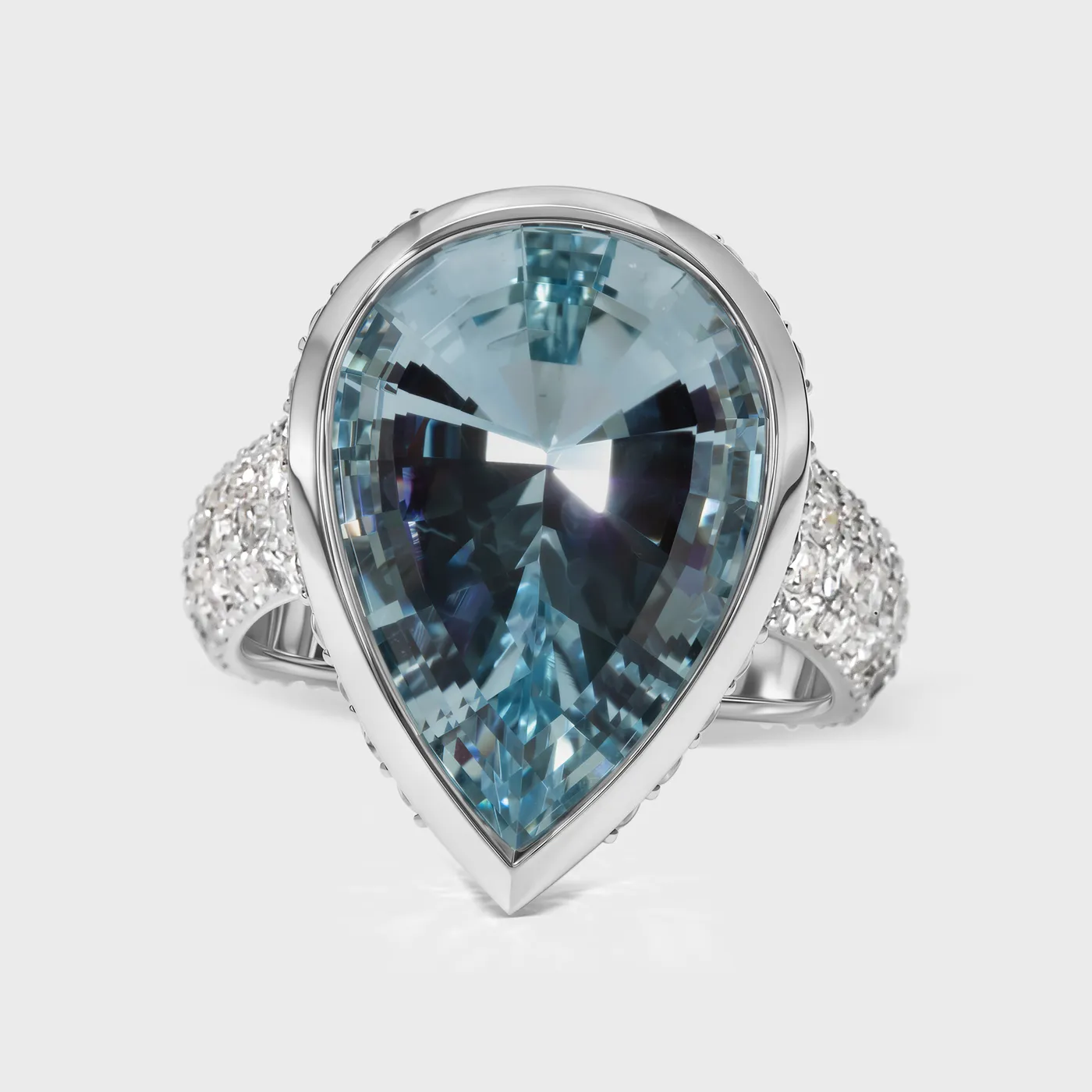 Donostia white gold ring by ValeOro with a pear-shaped blue aquamarine in a bezel and pavé diamond band, front view