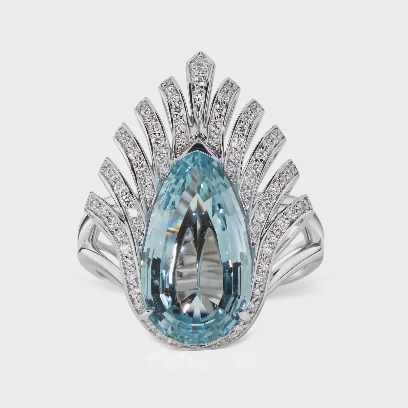 Living white gold ring by ValeOro with a pear-shaped light blue aquamarine framed by diamond rays, front view