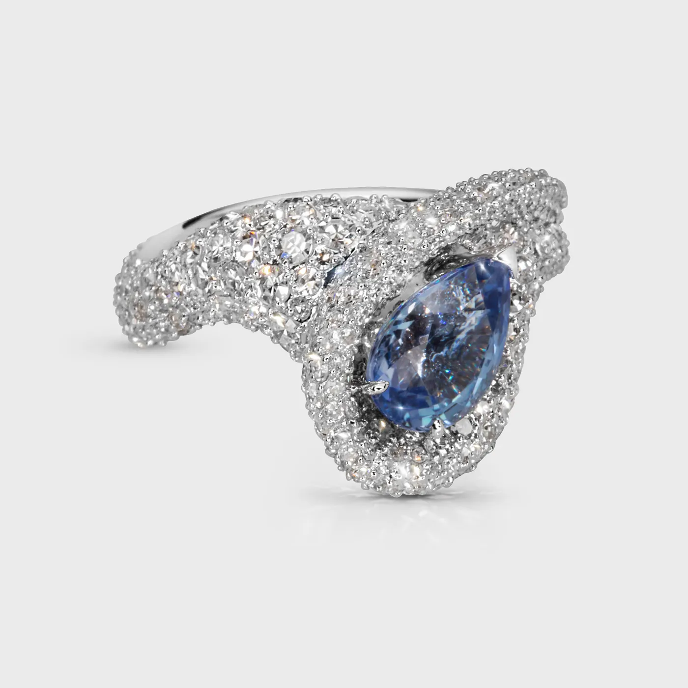 Yin-Yang Sapphire white gold ring by ValeOro with a pale blue pear-cut sapphire in a swirling diamond setting, side view