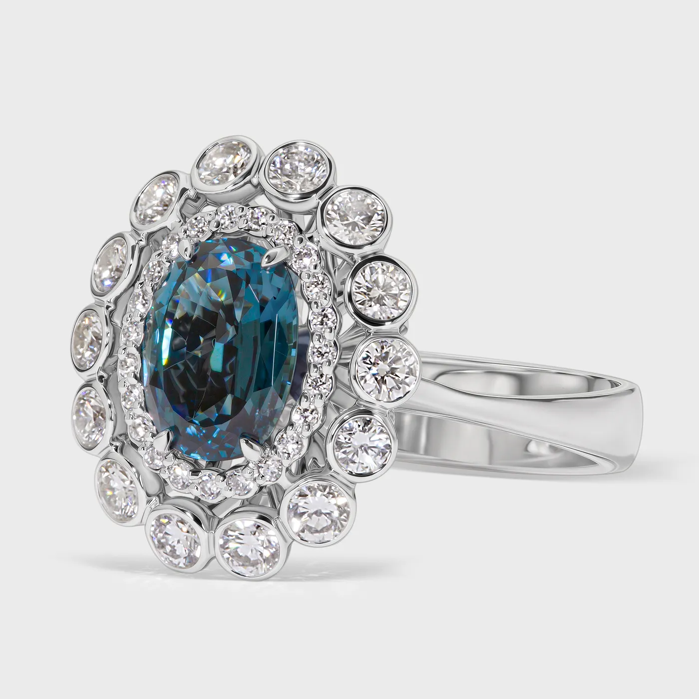 Sea white gold ring by ValeOro with an oval teal tourmaline framed by bezel-set diamonds, three-quarter view
