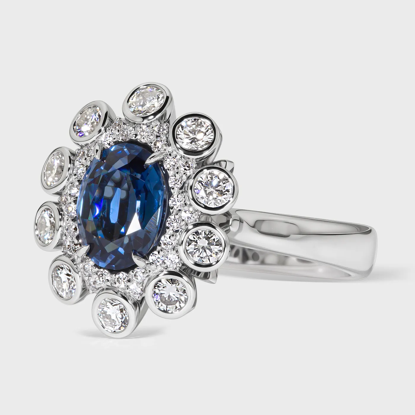 Nautico white gold ring by ValeOro with a blue sapphire in a floral diamond composition, side view