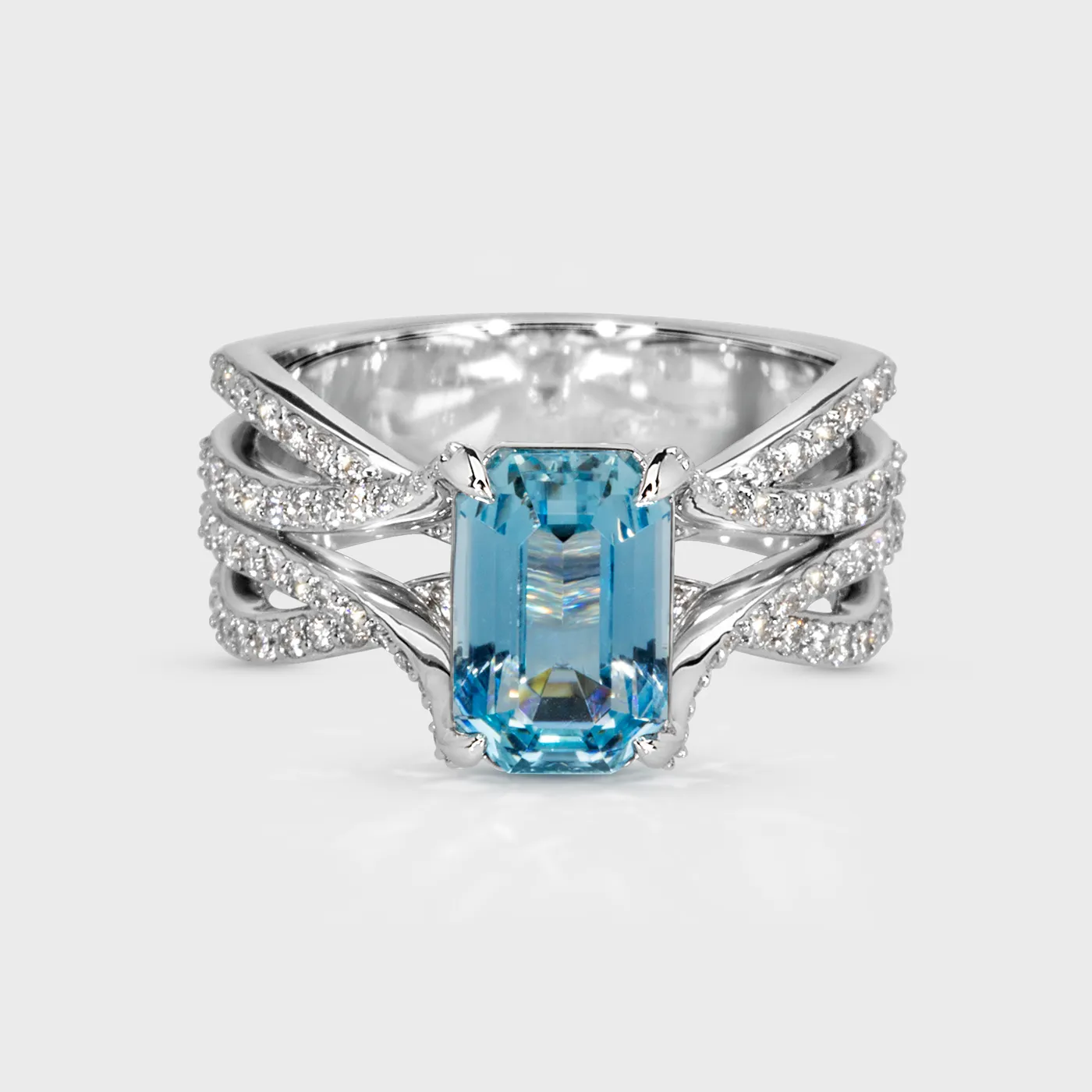 Baikal white gold ring by ValeOro with an emerald-cut blue aquamarine and intertwining diamond bands, front view