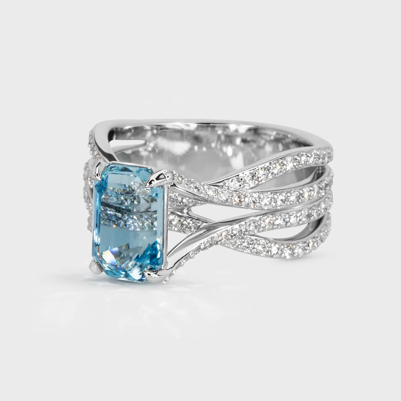 Baikal white gold ring by ValeOro with a blue aquamarine on a crossover diamond-set shank, three-quarter view