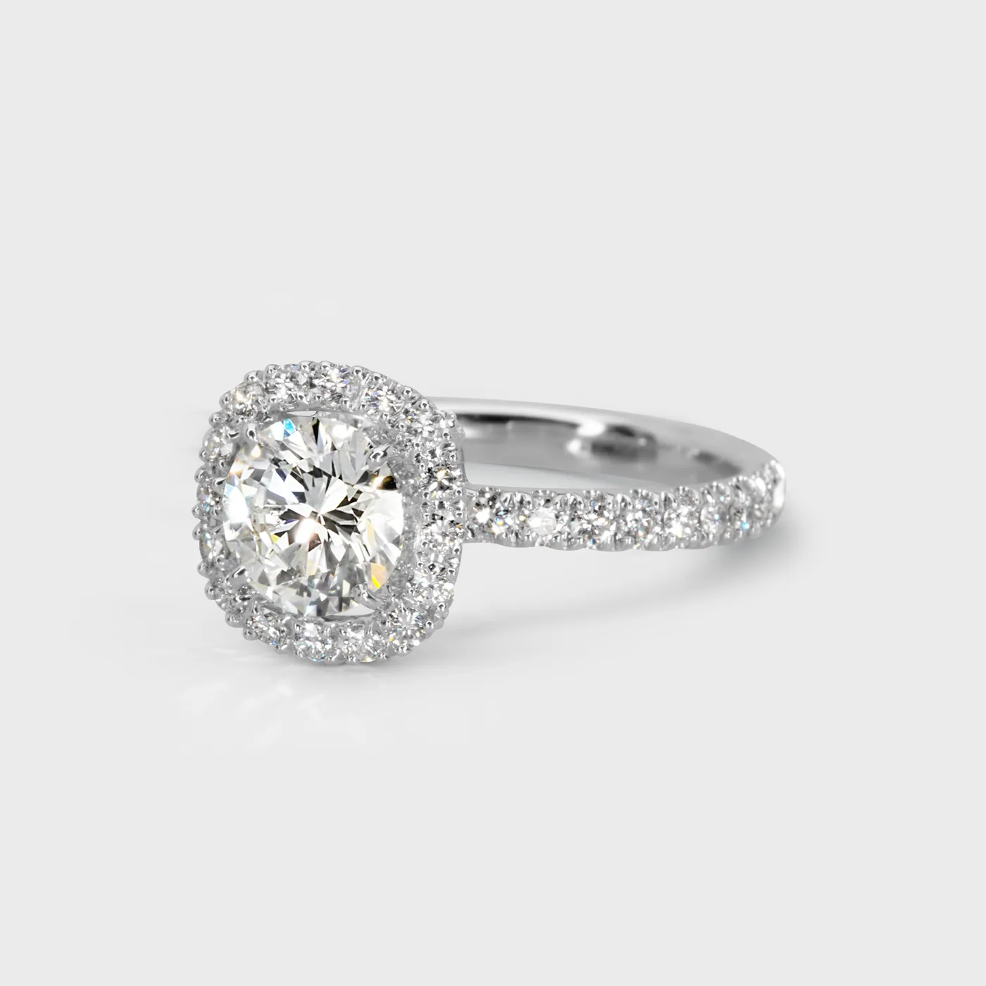 Radiance white gold ring by ValeOro with a round halo diamond and diamonds along the band, three-quarter view
