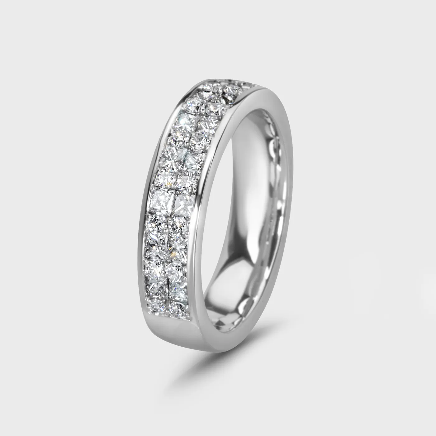 Linea white gold ring by ValeOro with princess-cut and round diamonds along the band, three-quarter view