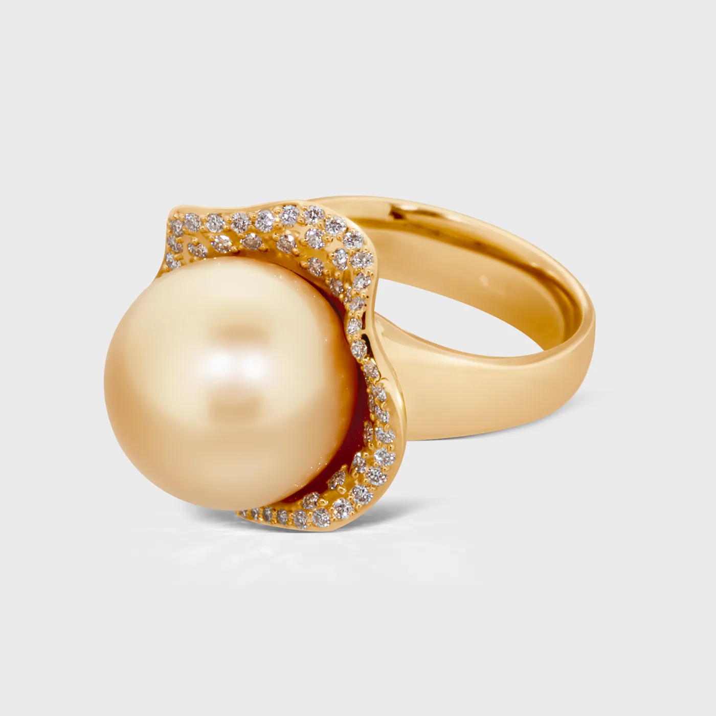 Tahiti Yellow ring in yellow gold by ValeOro with a round golden pearl in a diamond swirl setting, three-quarter view