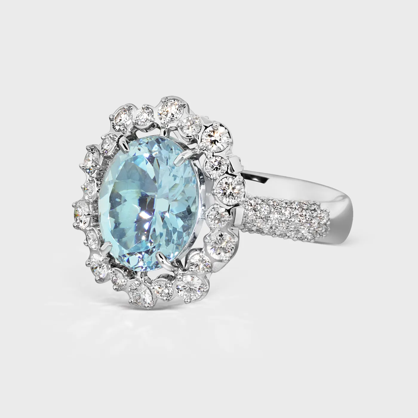 Salema white gold ring by ValeOro with an oval blue aquamarine and a diamond pavé band, three-quarter view