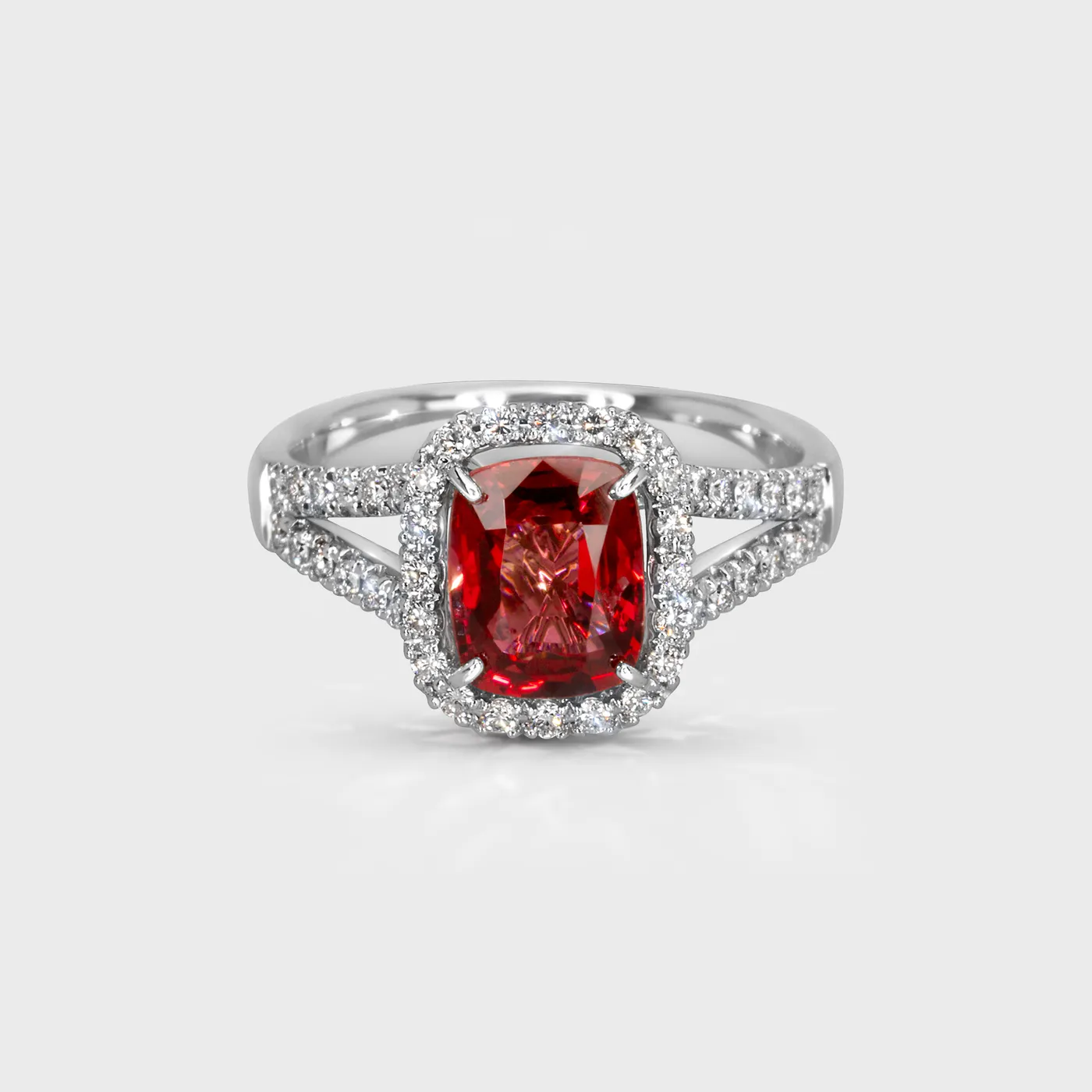 Eclat white gold ring by ValeOro with a cushion-cut red spinel in a diamond halo, front view