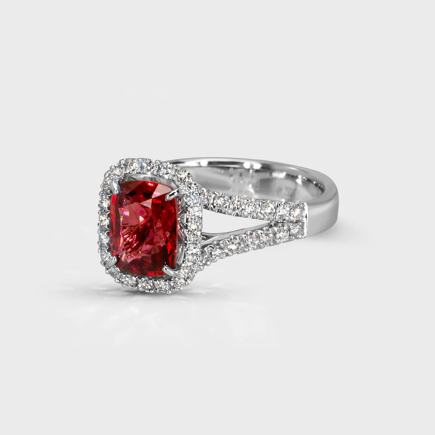 Eclat white gold ring by ValeOro with a red spinel framed by diamonds on a split pavé band, three-quarter view