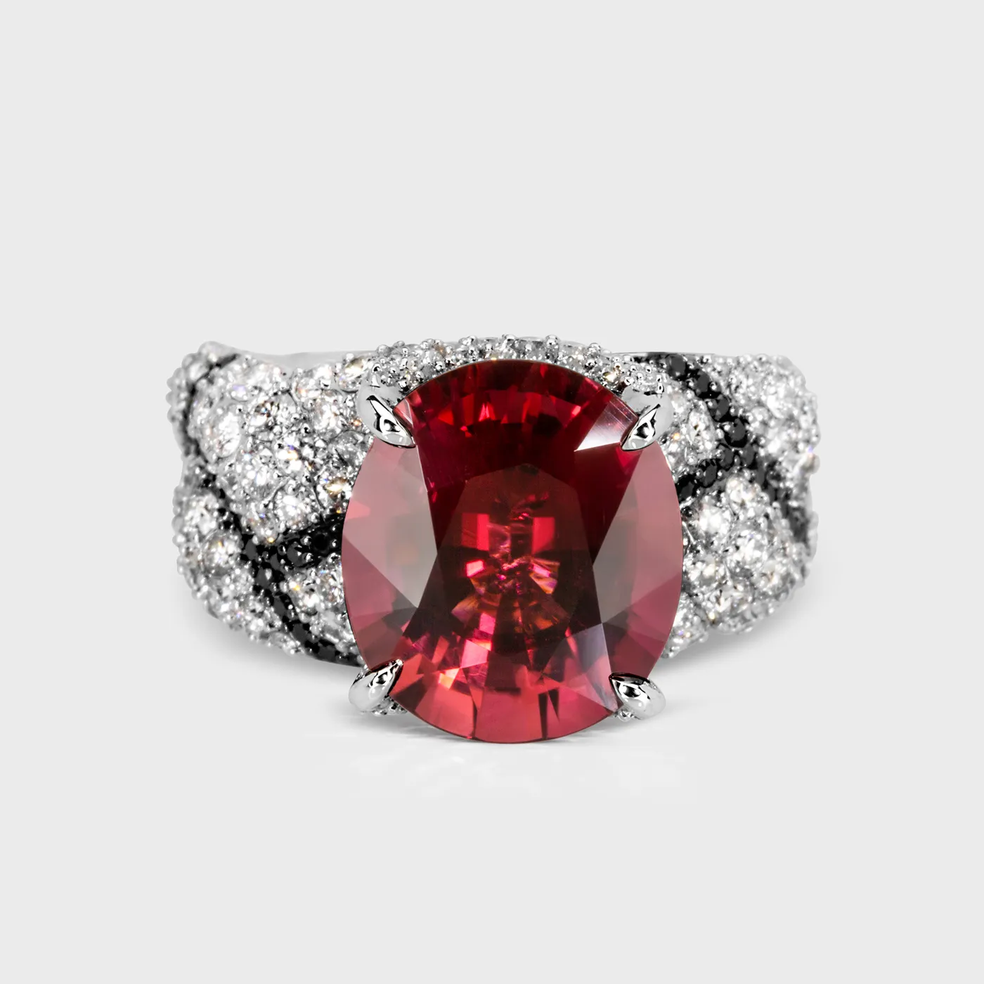 Oase white gold ring by ValeOro with an oval red tourmaline and white and black diamonds, front view