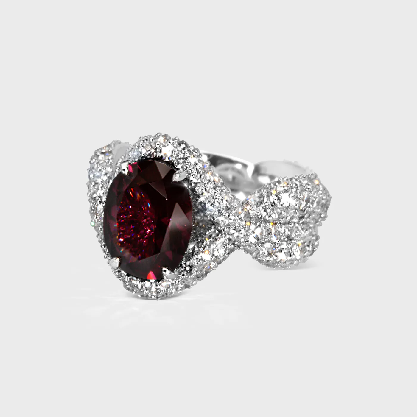 Paarl white gold ring by ValeOro with a deep-red oval spinel and diamond-set crossover shoulders, three-quarter view
