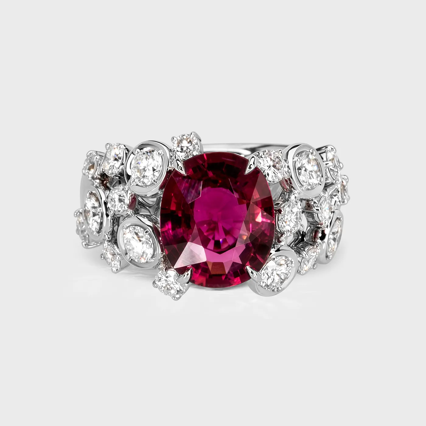 Ceres white gold ring by ValeOro with an oval red tourmaline flanked by diamonds in mirror bezel settings, front view