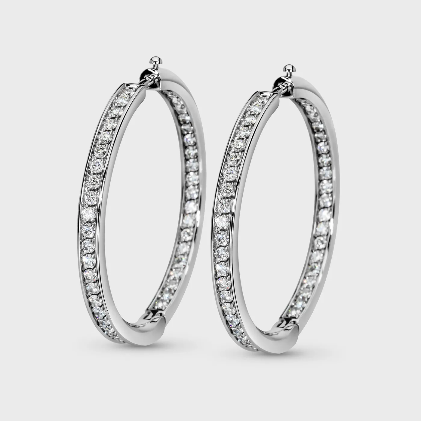 Chikalov white gold hoop earrings by ValeOro with diamonds set along the outer and inner sides, three-quarter view