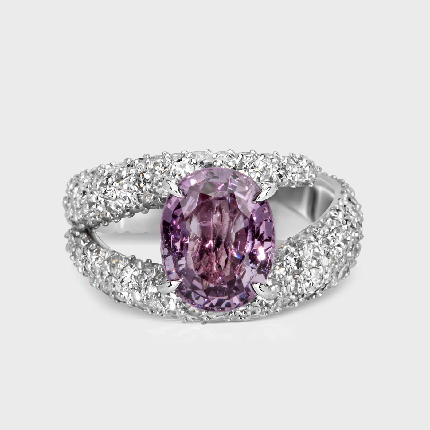 Onrus white gold ring by ValeOro with an oval violet spinel on a diamond-paved split shank, front view