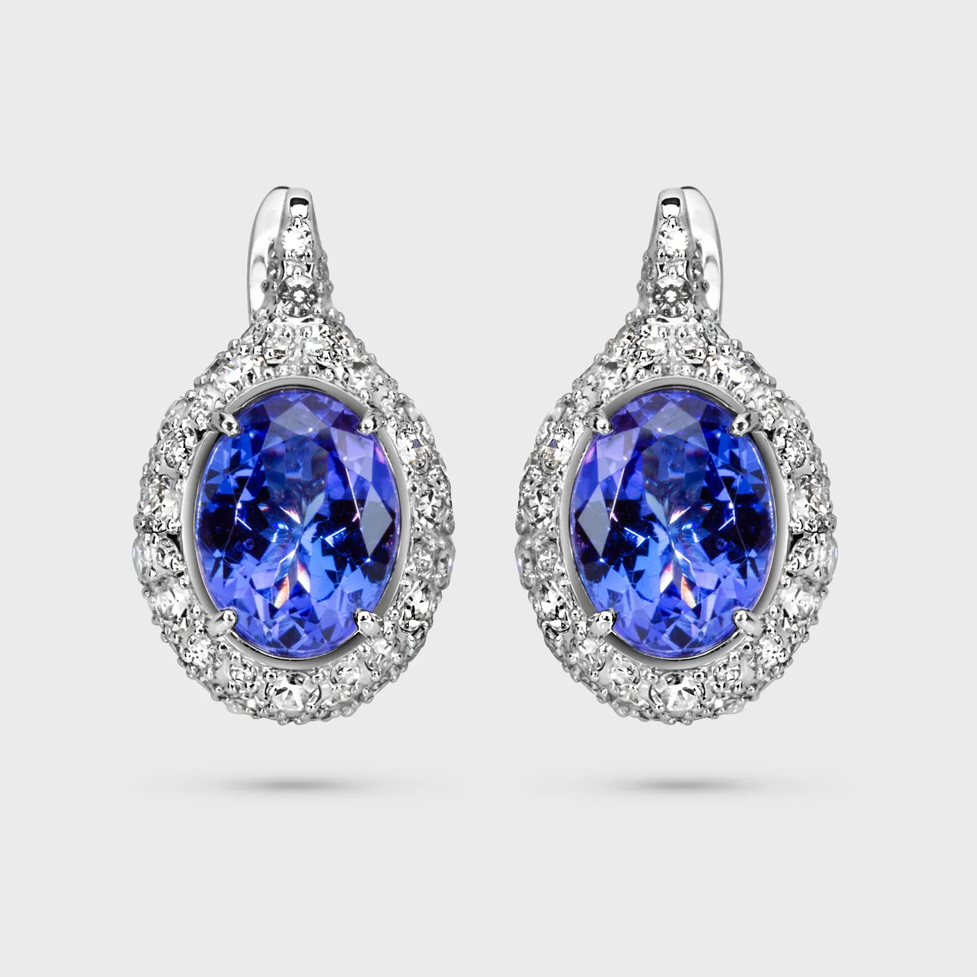 Arctic white gold earrings by ValeOro with oval blue-violet tanzanites framed by diamonds, front view