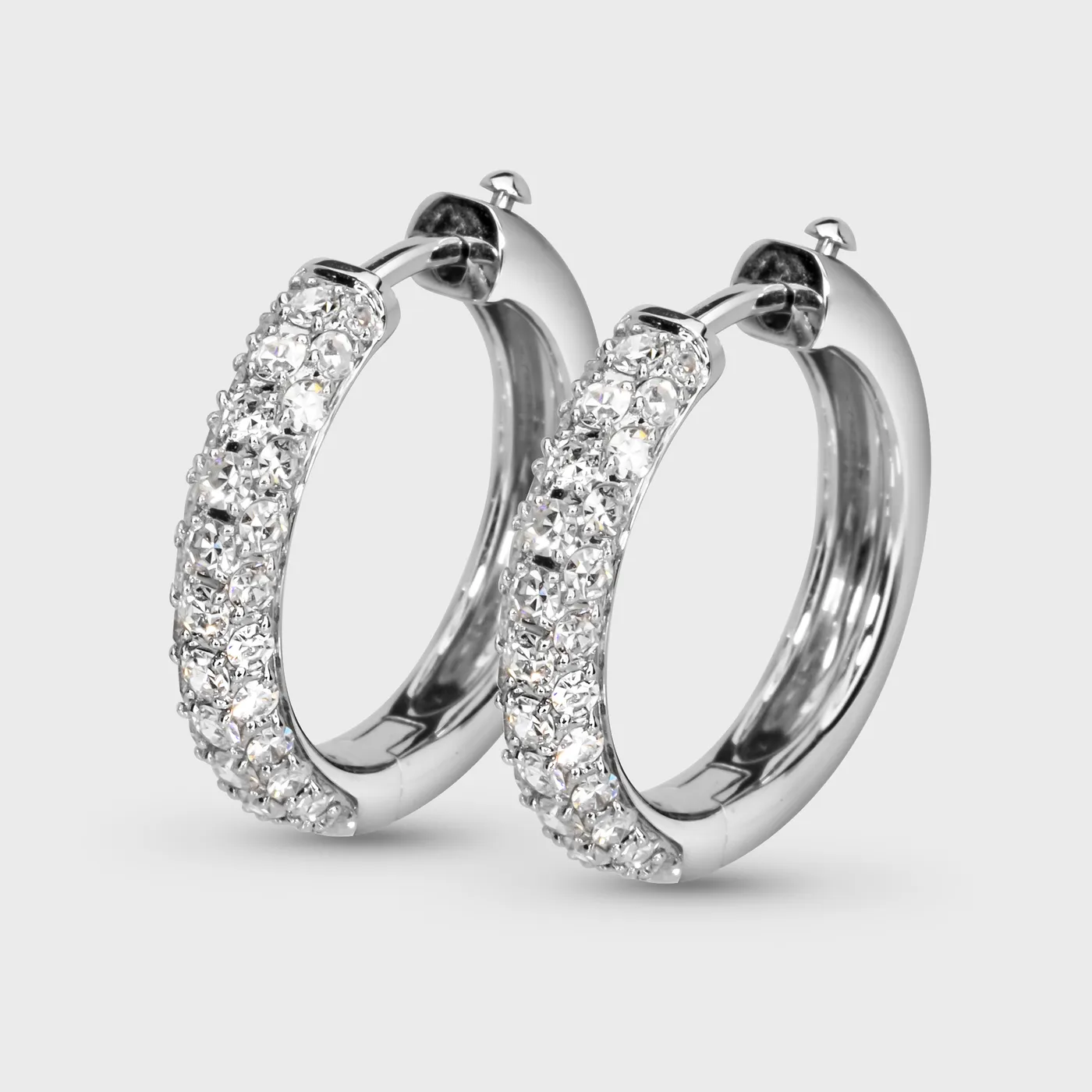 La Nucia white gold hoop earrings by ValeOro with pavé diamonds along the front, three-quarter view