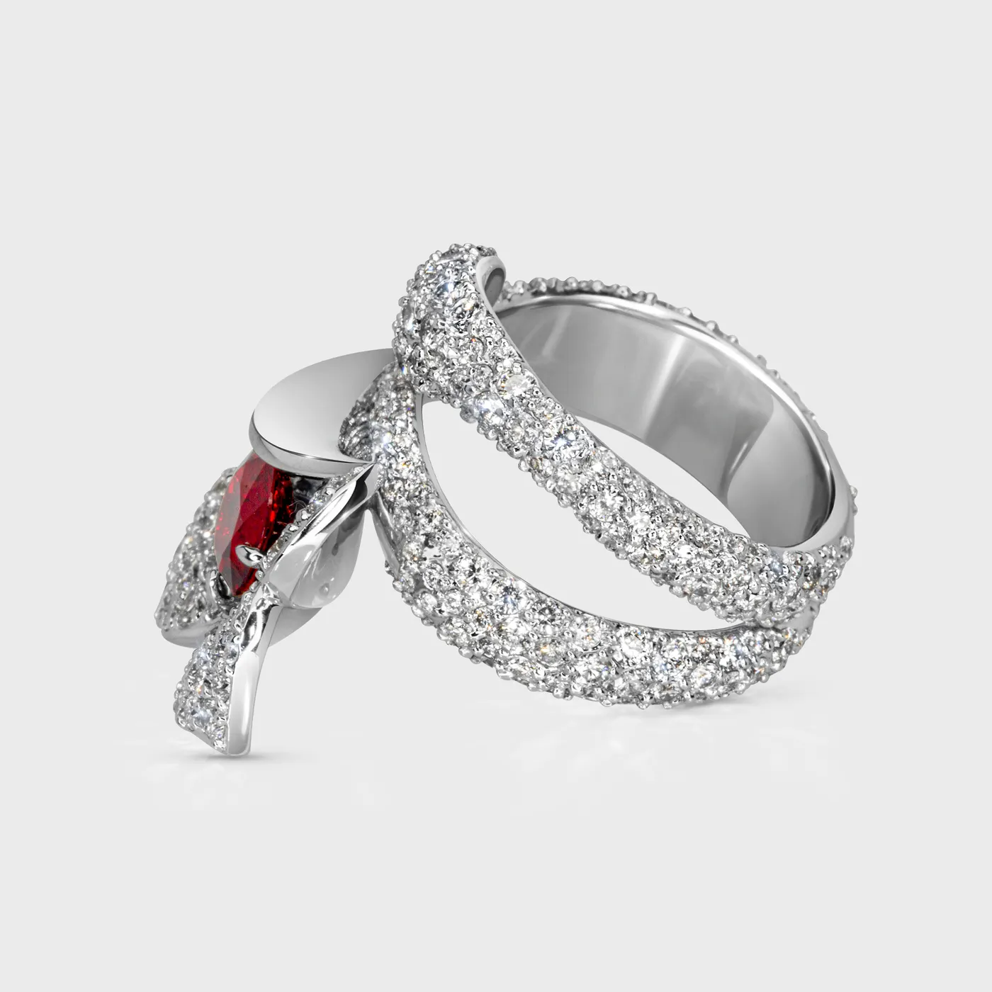 Lily white gold ring by ValeOro with a red sapphire and diamond-covered band, side view