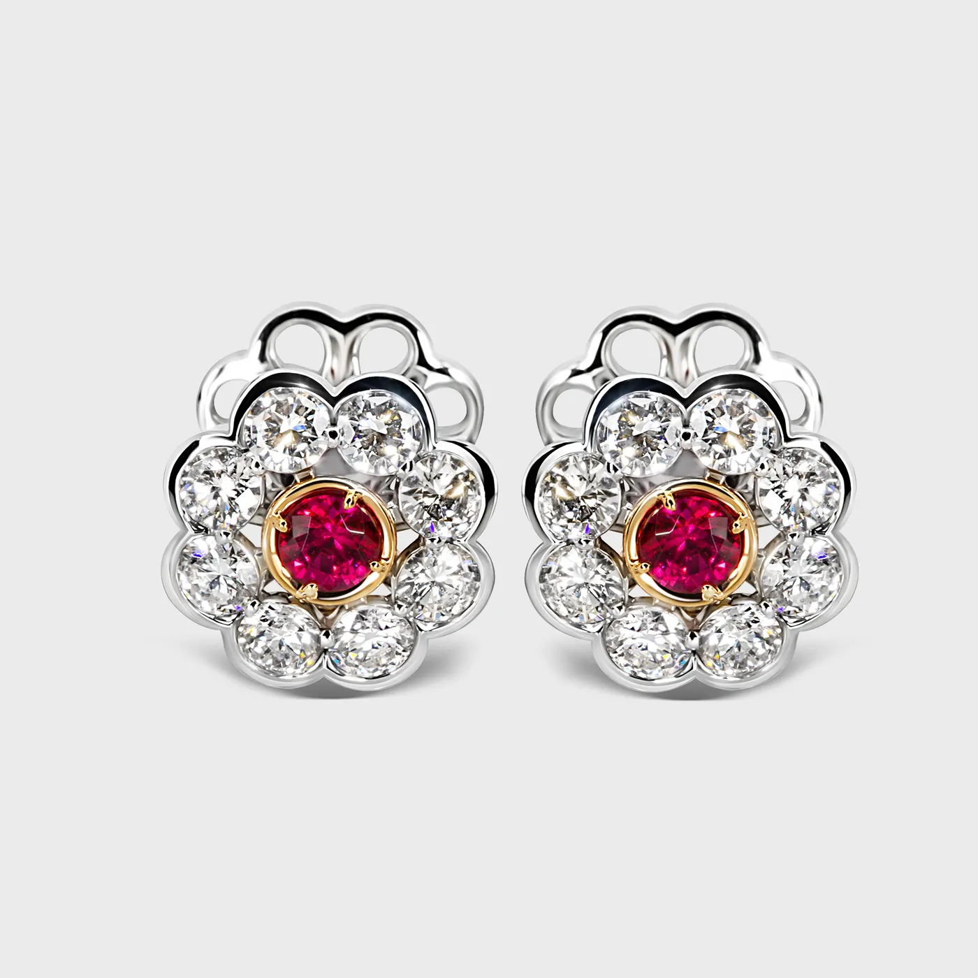 Amaryllis white gold earrings by ValeOro with round red spinels in yellow gold bezels framed by diamond petals, front view