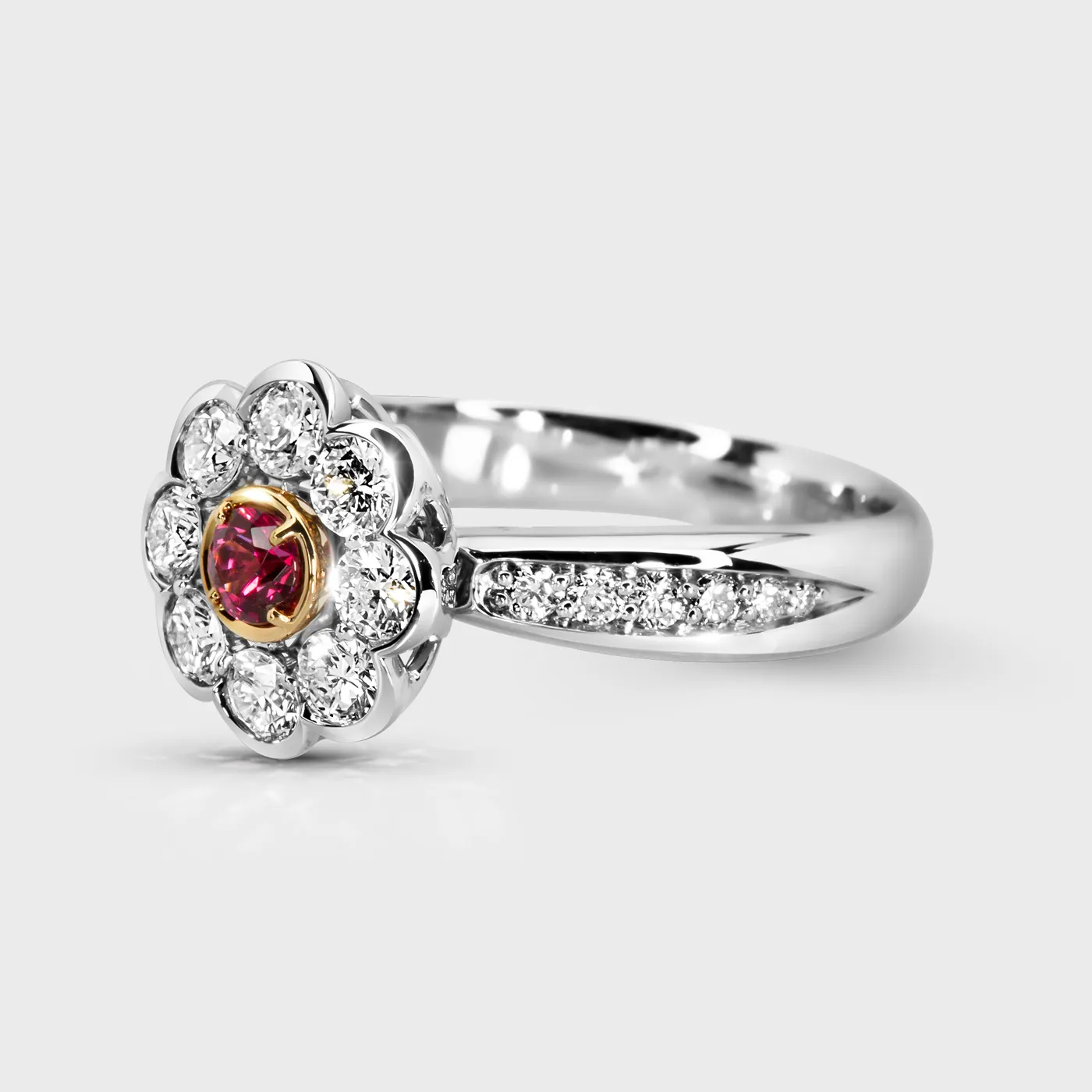 Amaryllis white gold ring by ValeOro with a red spinel flower head and diamond-set shoulders, three-quarter view