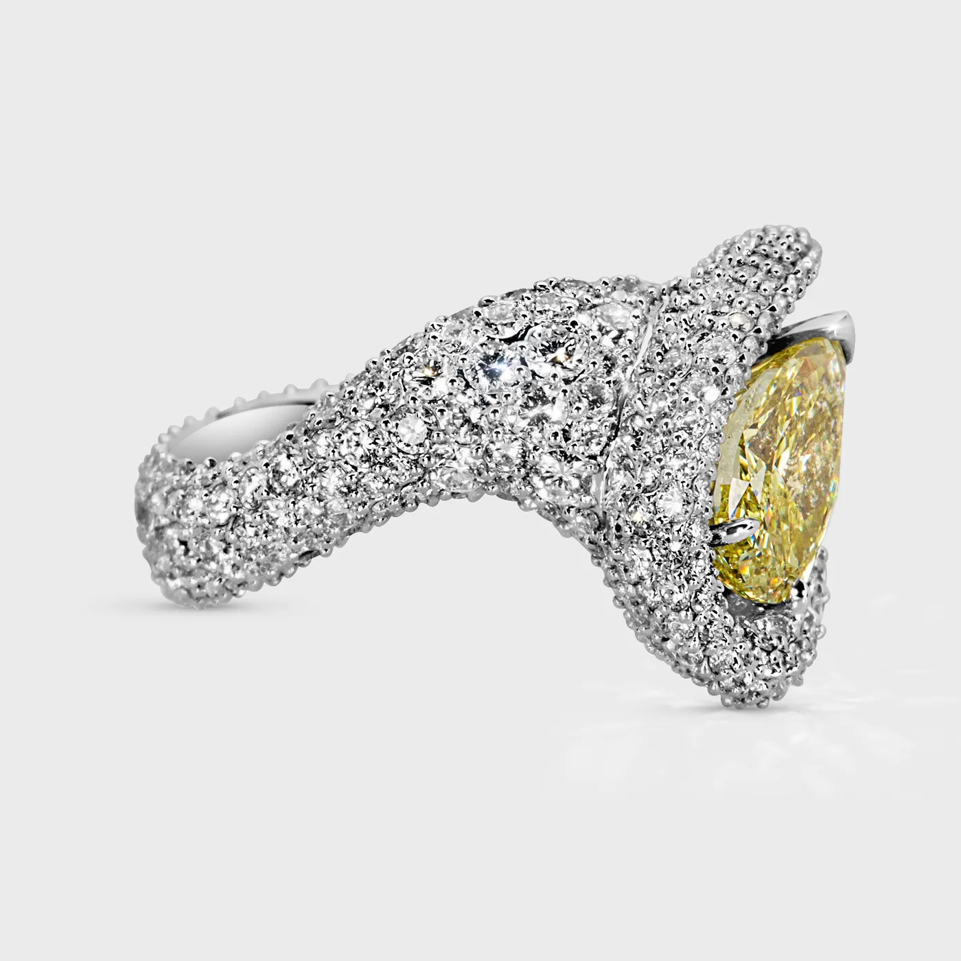 Yin-Yang white gold ring by ValeOro with a fully pavé-set wave band curving toward the yellow diamond, side view
