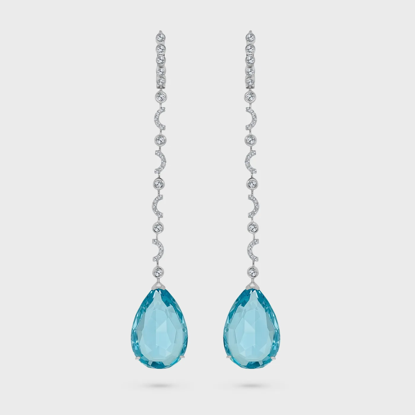 Soldeu Topaz white gold garland earrings by ValeOro with pear-shaped blue topaz drops below lines of diamonds, front view