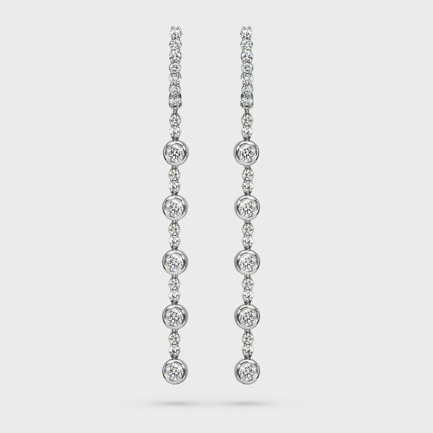 Asti white gold drop earrings by ValeOro with a vertical cascade of bezel-set round diamonds, front view