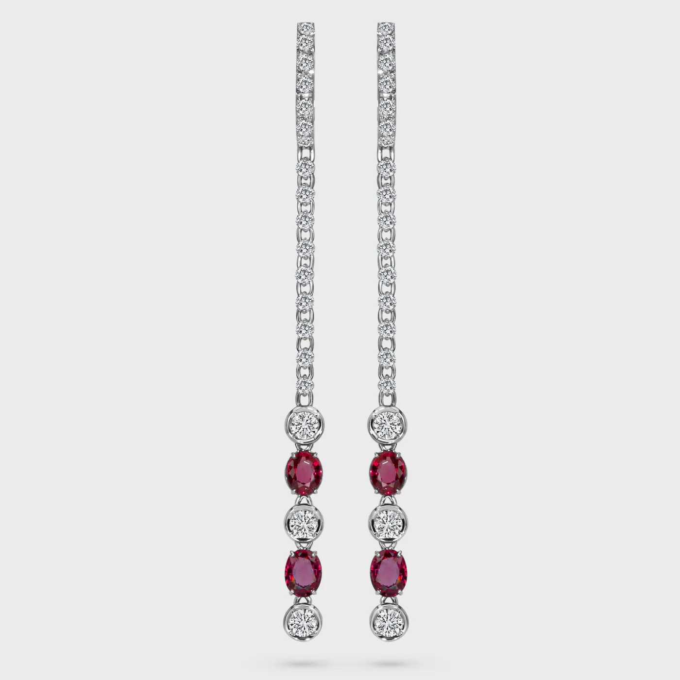 Grape white gold drop earrings by ValeOro with oval red spinels and round diamonds in a vertical line, front view