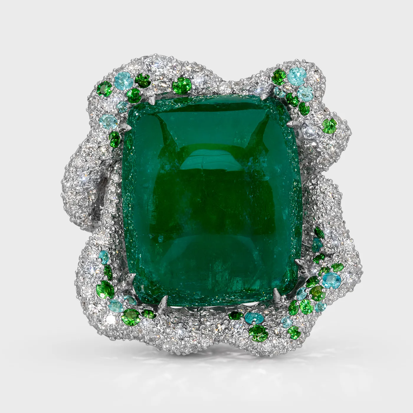 Crown of Ural white gold ring by ValeOro with a green cabochon emerald framed by diamonds and green accents, front view
