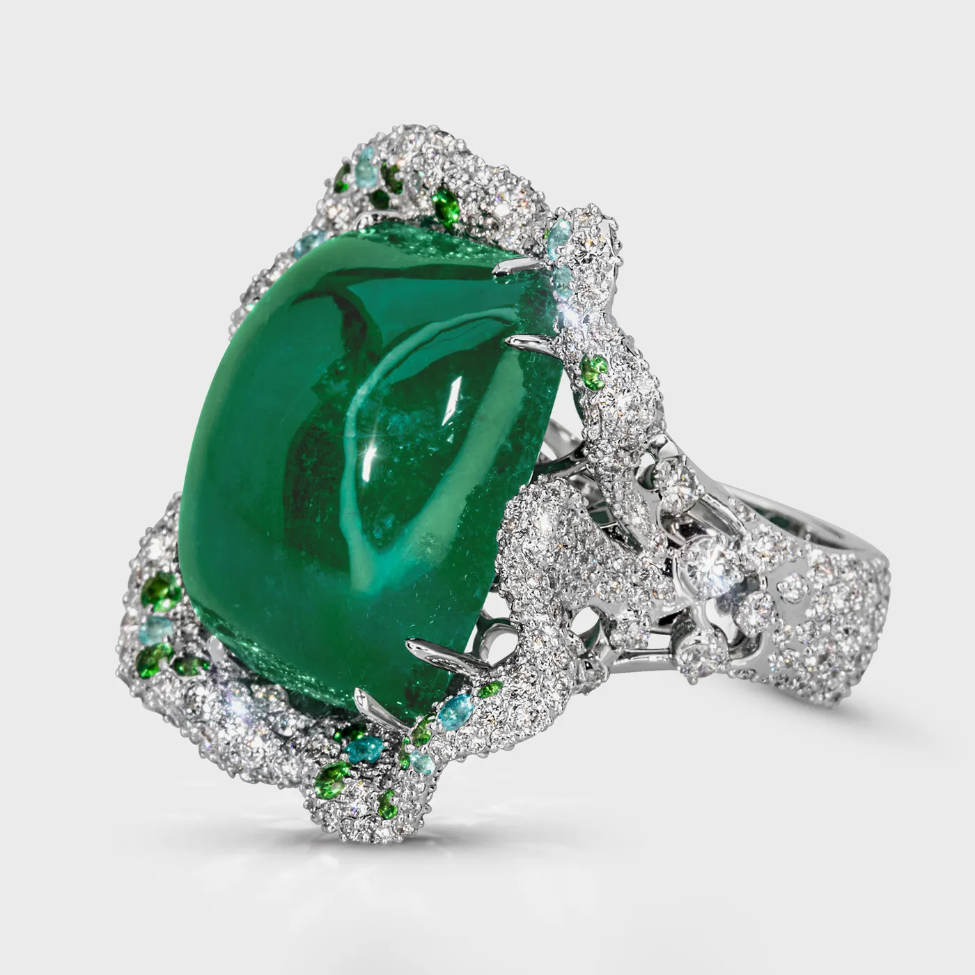 Crown of Ural white gold ring by ValeOro with a high-domed green emerald and diamond-set shoulders, three-quarter view