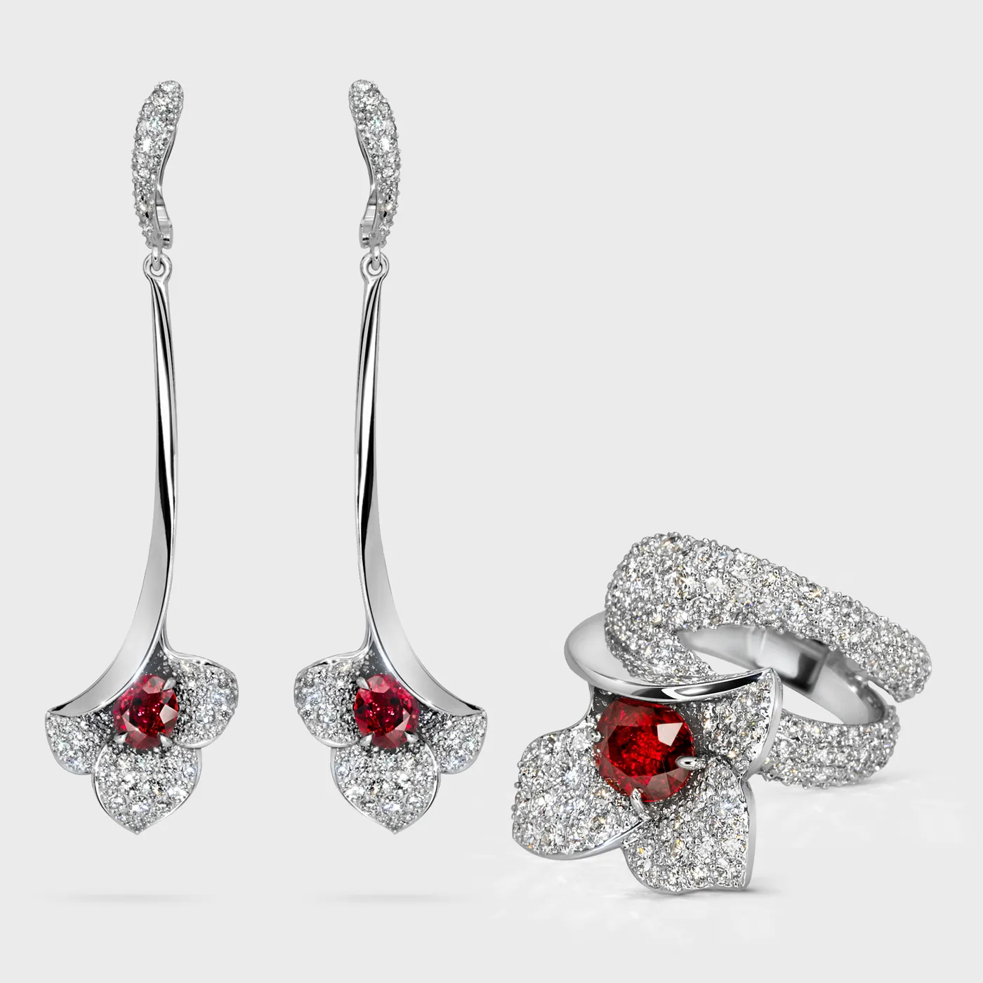Lily white gold jewelry set by ValeOro with red sapphires in diamond flowers, earrings and ring
