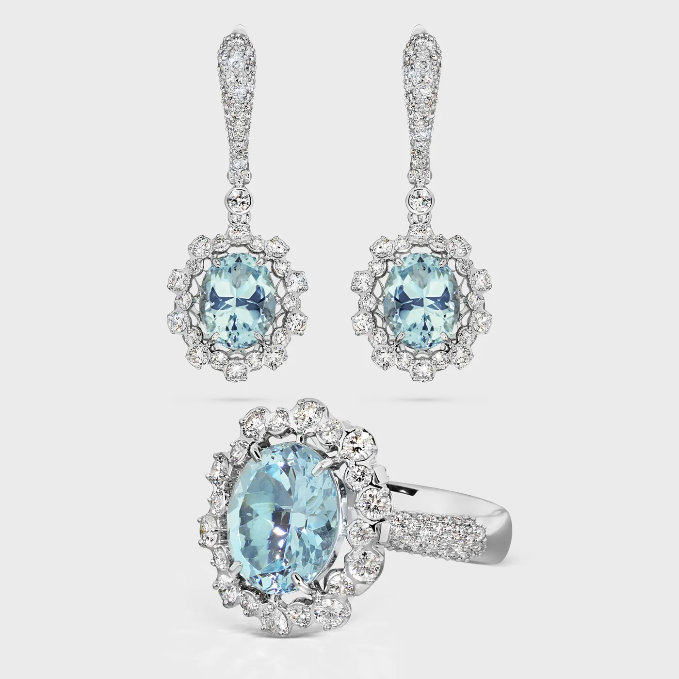 Salema white gold jewelry set by ValeOro with oval blue aquamarines framed by diamond halos, ring and drop earrings