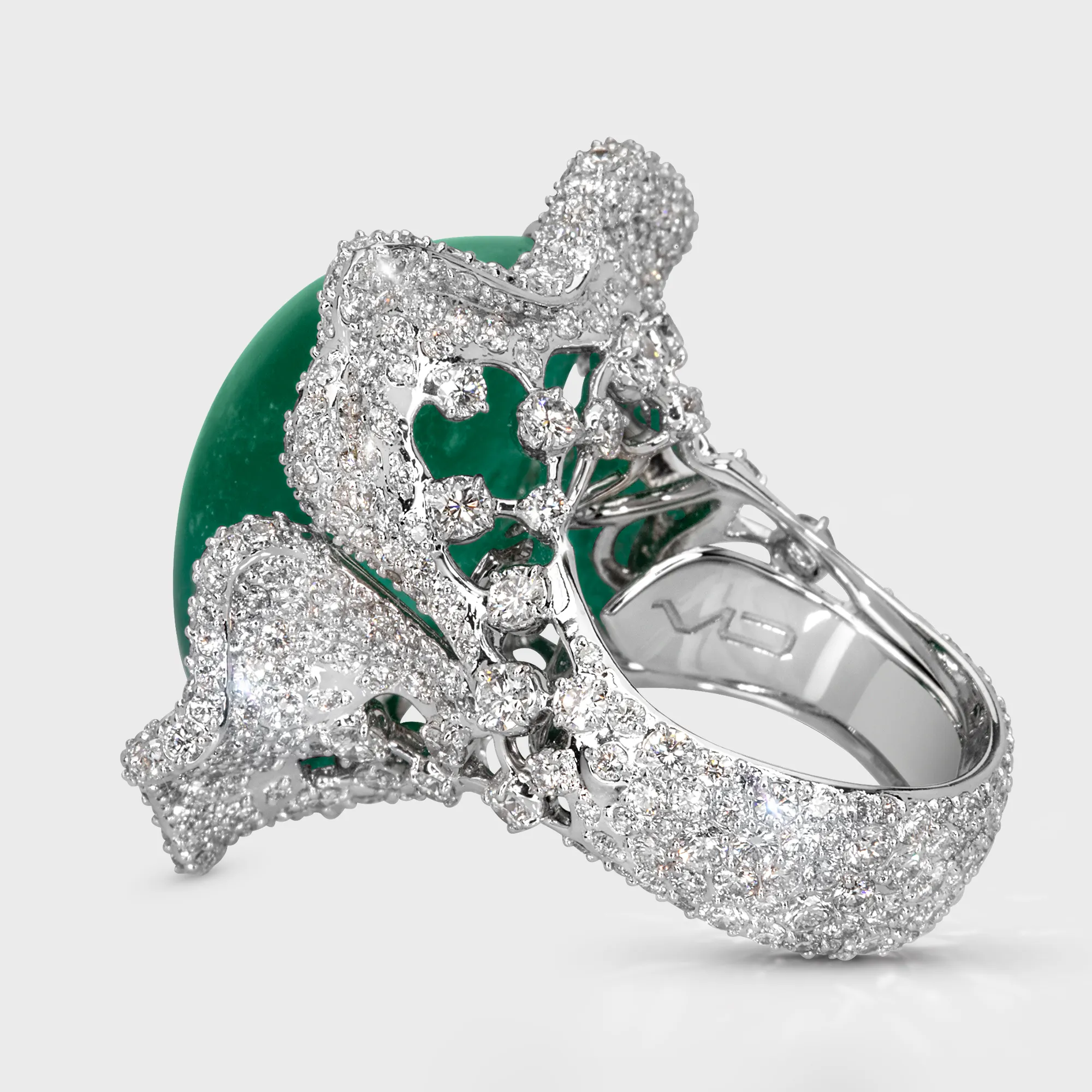 Crown of Ural white gold ring by ValeOro showing the openwork diamond gallery and emerald in profile, side view
