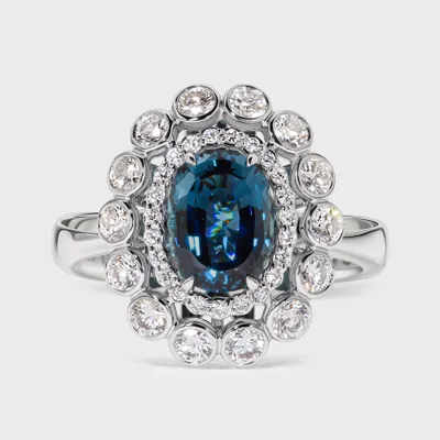 Sea white gold ring by ValeOro with an oval blue-green tourmaline in a double-halo floral diamond setting, front view