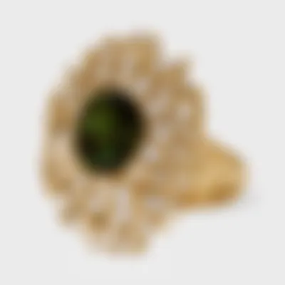 Cadiz yellow gold ring by ValeOro with a green tourmaline among interwoven gold lines set with diamonds, three-quarter view