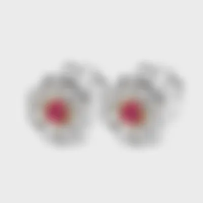 Amaryllis white gold earrings by ValeOro with red spinel centers in yellow gold and a diamond flower halo, three-quarter view