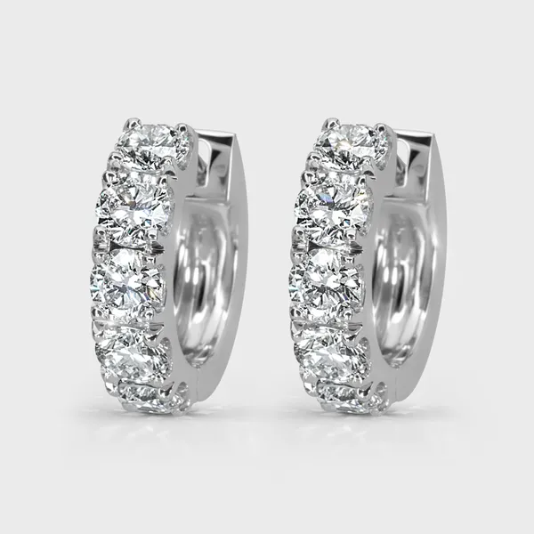 Gloss white gold hoop earrings by ValeOro set with round diamonds along the front, three-quarter view