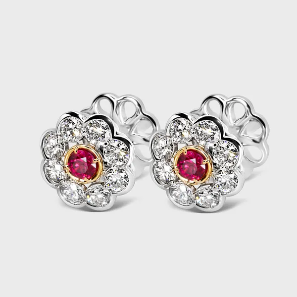 Amaryllis white gold earrings by ValeOro with red spinel centers in yellow gold and a diamond flower halo, three-quarter view