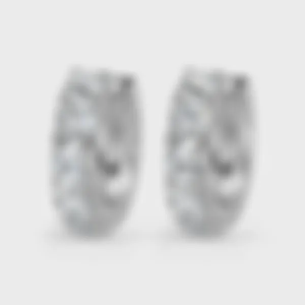 Gloss white gold hoop earrings by ValeOro set with round diamonds along the front, three-quarter view