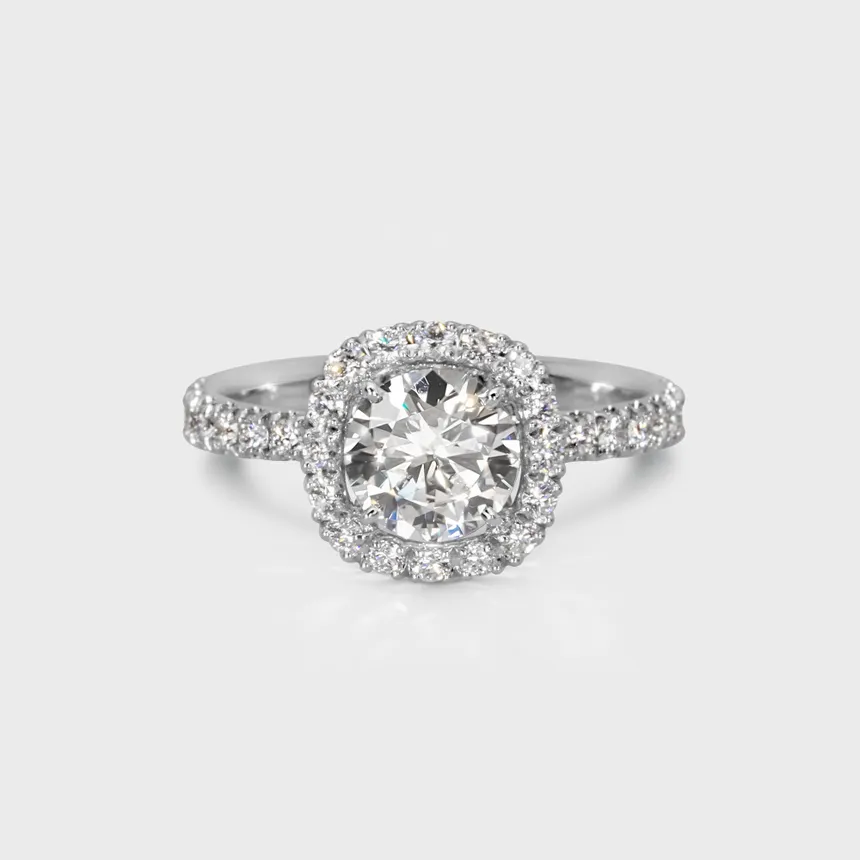 Radiance white gold ring by ValeOro with a round central diamond in a diamond halo and a pavé-set band, front view
