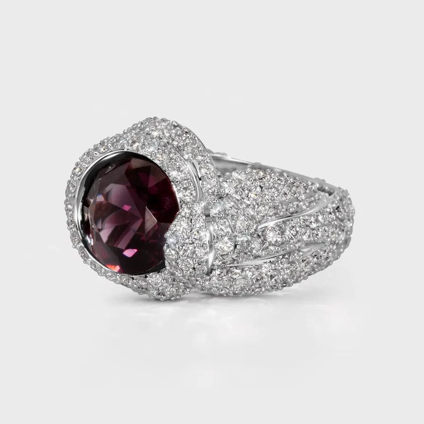Liaison white gold ring by ValeOro with a round purple spinel and pavé diamond shoulders, three-quarter view
