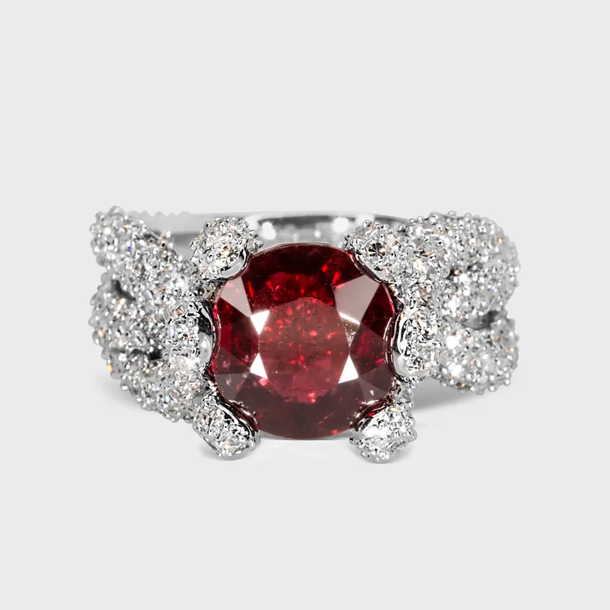 Caledon white gold ring by ValeOro with a round red spinel in a woven pavé diamond band, front view