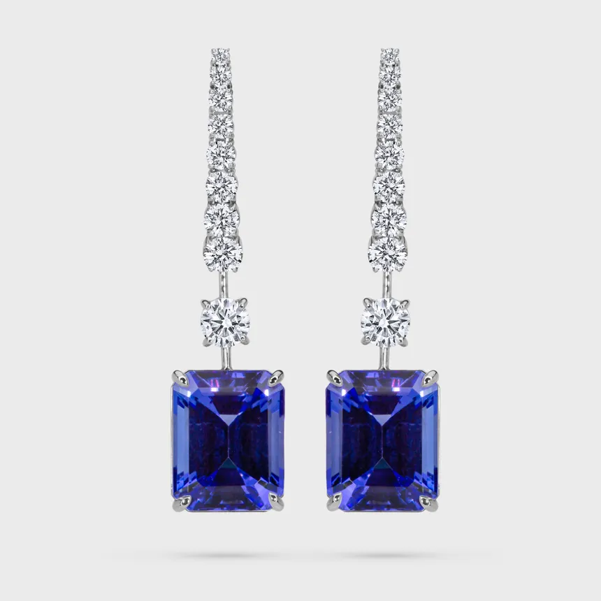 Sorteny Tanzanite white gold earrings by ValeOro with emerald-cut blue-violet tanzanites on a line of diamonds, front view