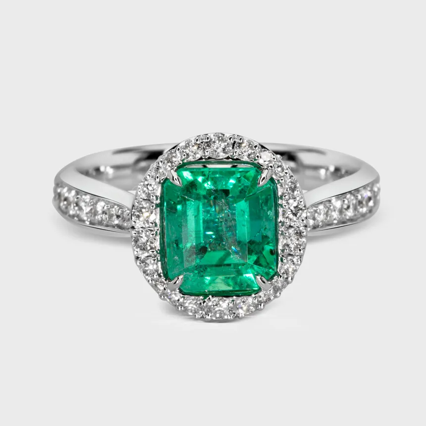 Ural white gold ring by ValeOro with a rectangular green emerald framed by a diamond halo, front view