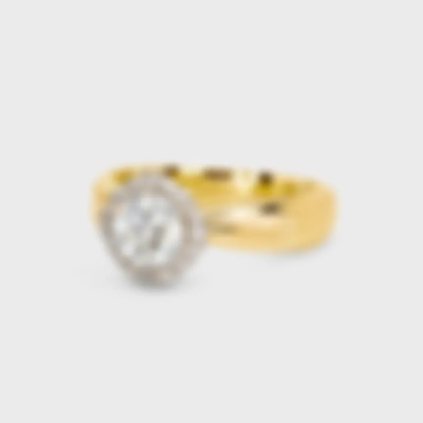 Halo yellow gold ring by ValeOro with a round brilliant-cut diamond in a white gold diamond halo, three-quarter view