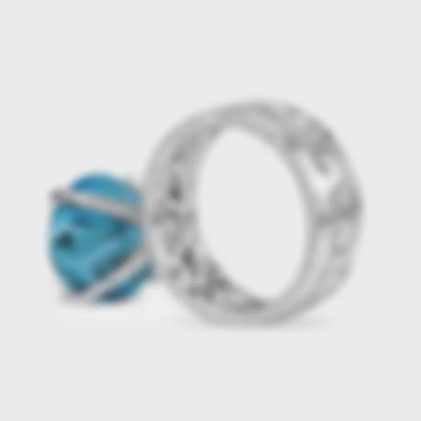 Chambord white gold ring by ValeOro with a diamond-set scrollwork band and a blue aquamarine, side view