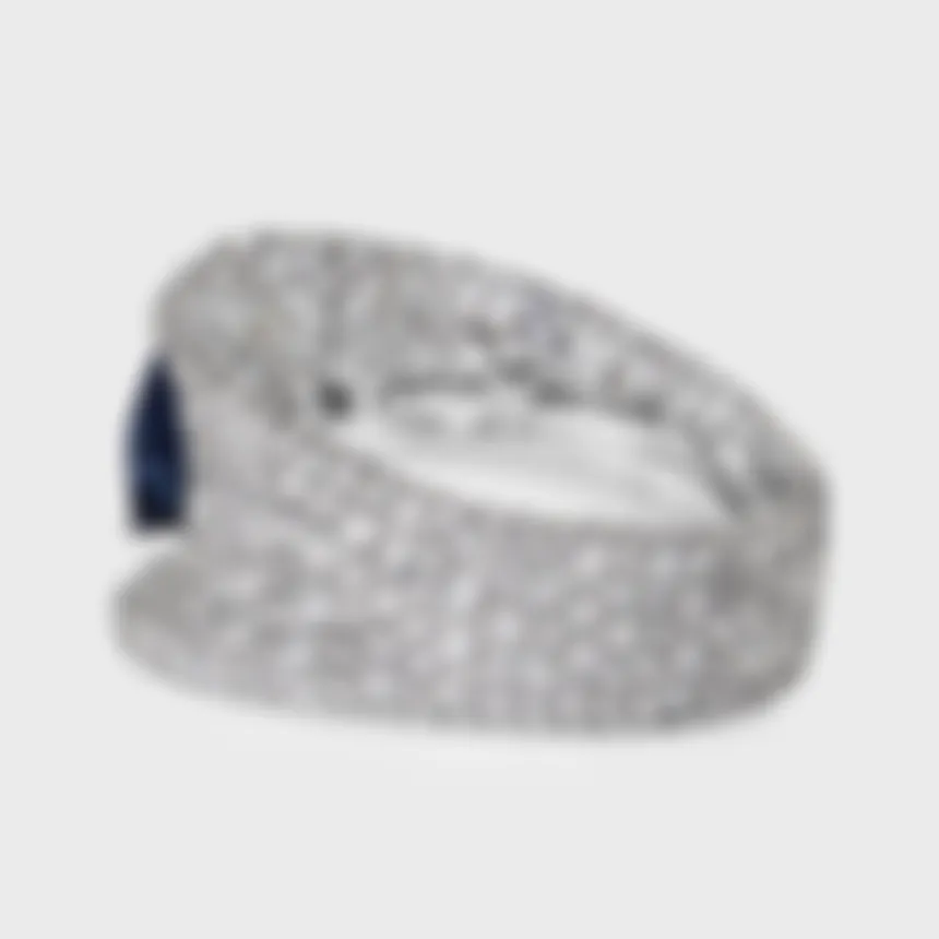 La Massana white gold ring by ValeOro with a wide pavé diamond band and a blue sapphire, side view