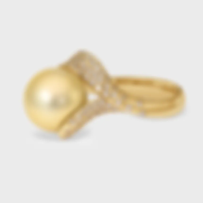 Makemo Yellow gold ring by ValeOro, golden pearl with a twisting diamond pavé band, side view