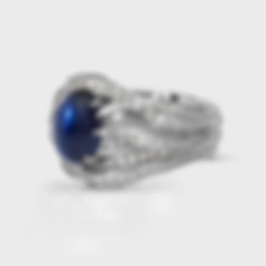 Astraea white gold ring by ValeOro with a blue cabochon sapphire and diamond-set flowing lines, side view